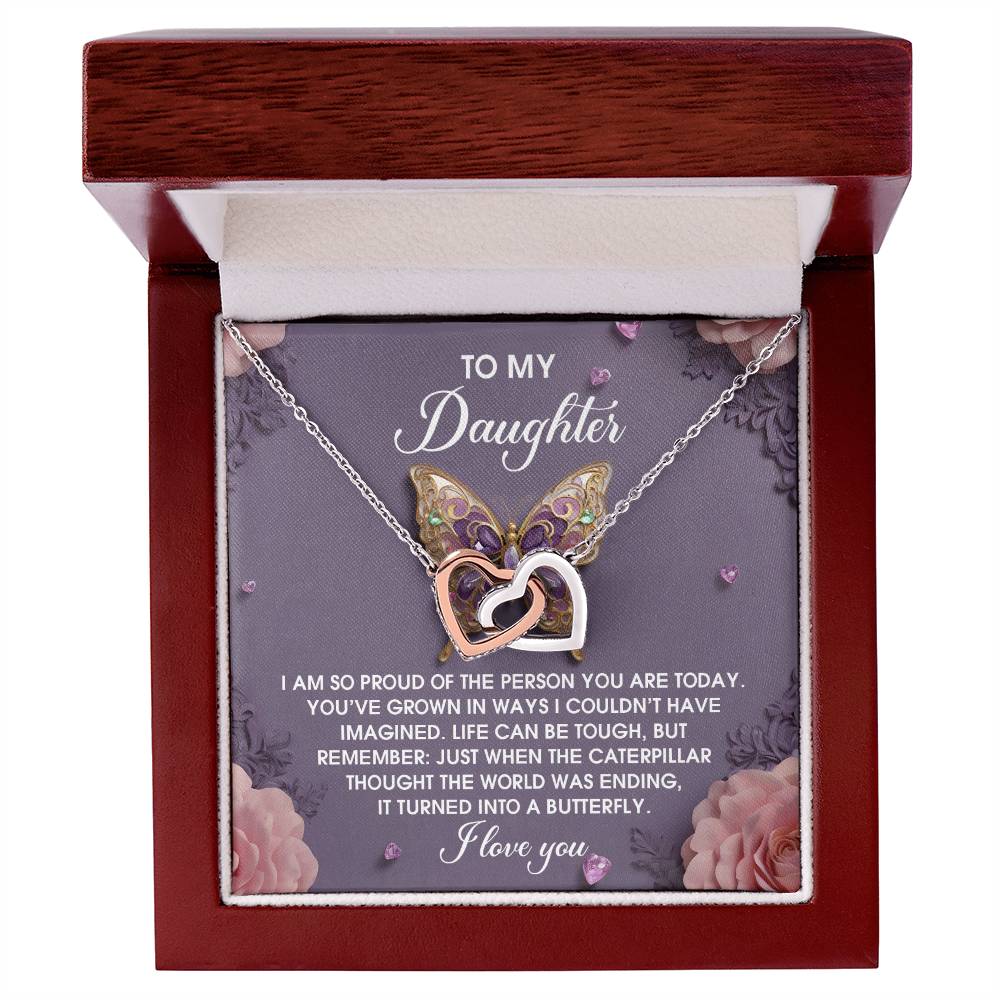 The Daughter-A Butterfly - Interlocking Hearts Necklace has a rose gold finish and sparkling cubic zirconia crystals, accompanied by a heartfelt message for your daughter in its box.