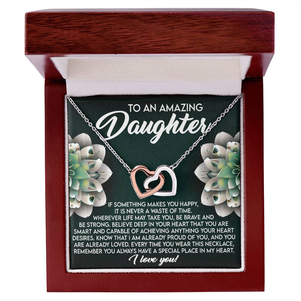 The Daughter-Special Place - Interlocking Hearts Necklace, made from surgical steel with a rose gold finish, comes in a wooden box. It features cubic zirconia crystals and a heartfelt message about happiness, bravery, and love for your daughter.