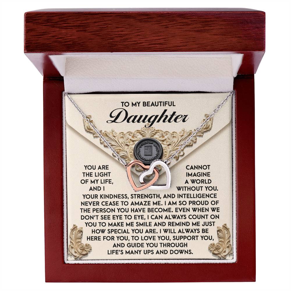 The Daughter-Amaze Me - Interlocking Hearts Necklace, featuring shimmering cubic zirconia crystals and a rose gold finish, is presented in a jewelry box with a heartfelt message expressing love and support to a daughter.