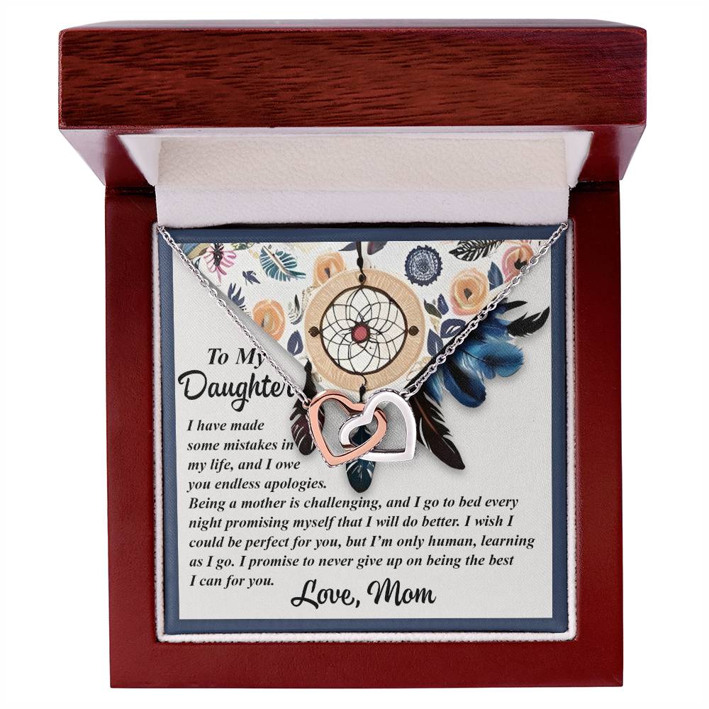 A wooden box displays the "Daughter-For You - Interlocking Hearts Necklace" with cubic zirconia crystals. The lid says, "To My Daughter," with a loving message from mom about love, support, and perseverance.