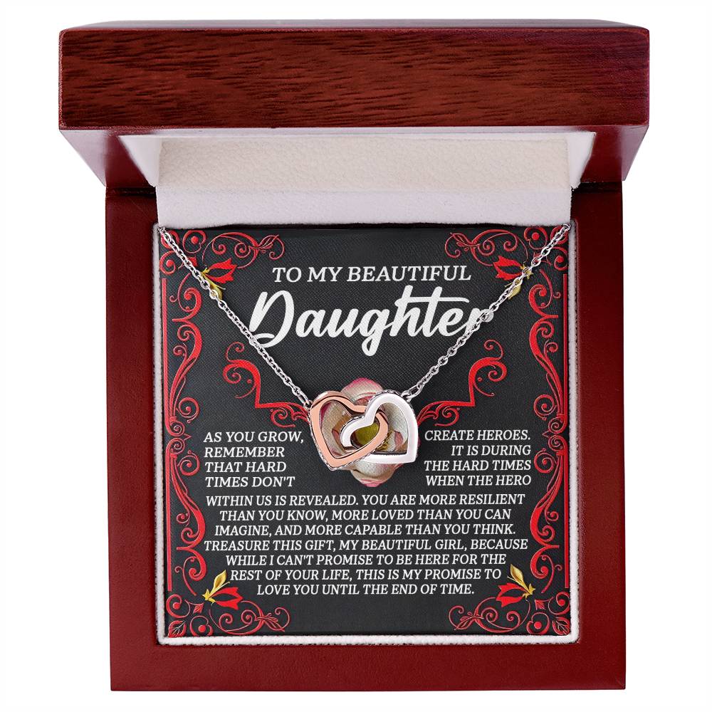 The Daughter-Hard Times Interlocking Hearts Necklace, in a rose gold finish, sits in an open box. The lid reads "To my beautiful daughter," with red swirls and cubic zirconia crystals, followed by an inspirational message.