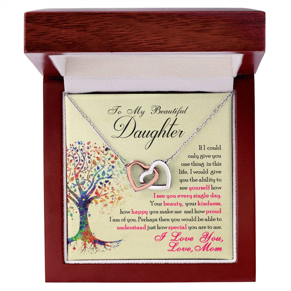 A ShineOn Fulfillment necklace with interlocking hearts and cubic zirconia crystals in a gift box, accompanied by a sentimental message to a daughter from a parent.