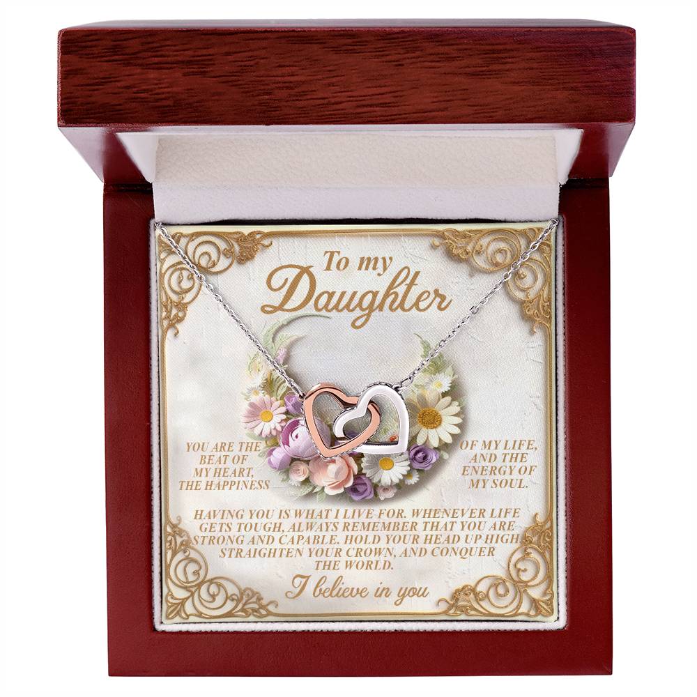 The Daughter-Heart Happiness Interlocking Hearts Necklace, with a rose gold finish and cubic zirconia-adorned hearts, comes in a "To my Daughter" wooden box featuring a heartfelt message framed by floral illustrations and a white interior.