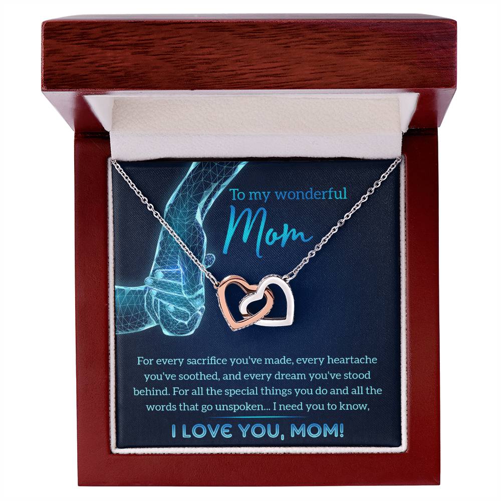 The "To Mom, Stood Behind - Interlocking Hearts Necklace," adorned with sparkling cubic zirconia crystals, is elegantly presented in a jewelry box with a heartfelt message card for "Mom," making it the perfect personalized gift to cherish forever.