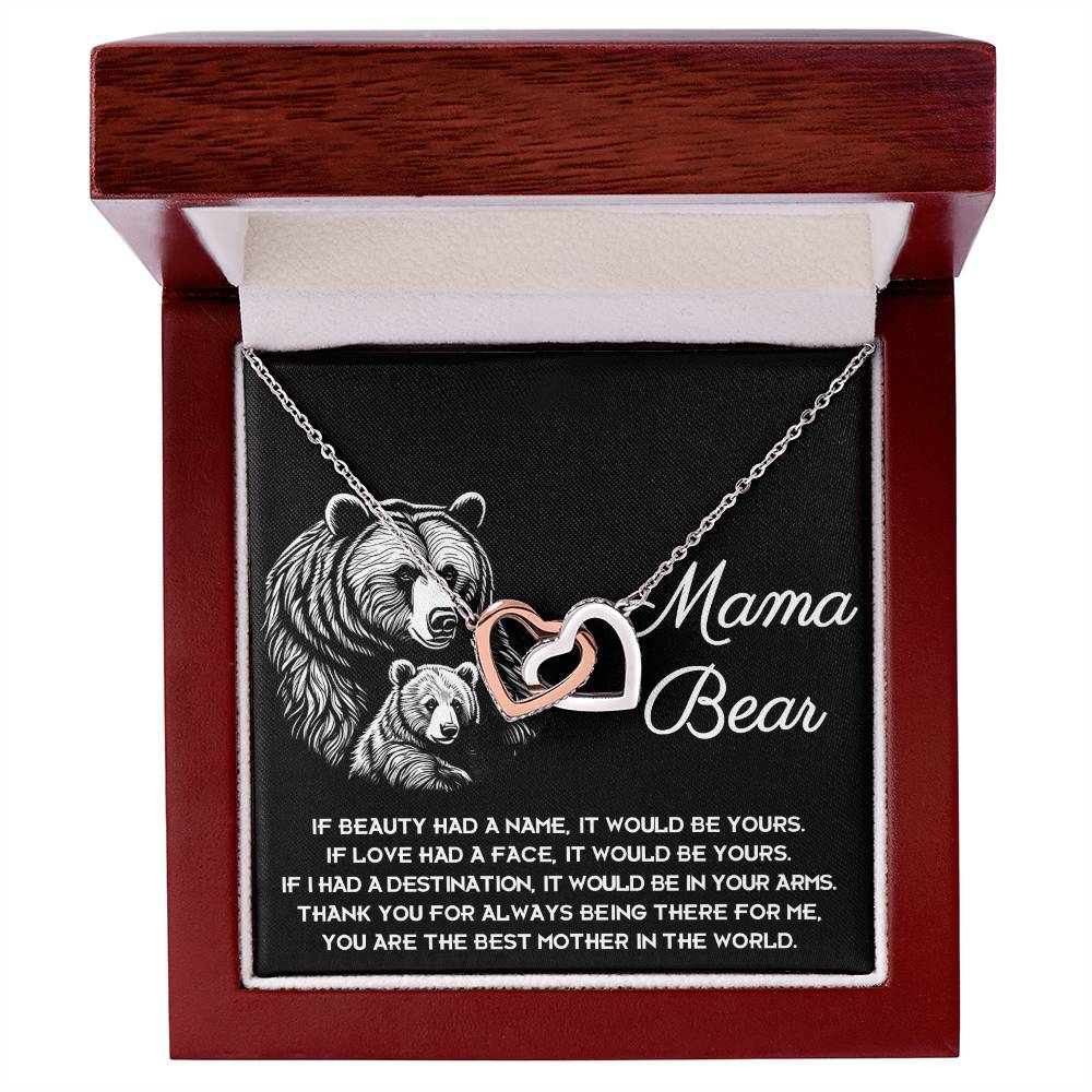 The "To Mom, In Your Arms - Interlocking Hearts Necklace" is a personalized gift with sparkling cubic zirconia crystals, nestled in a "Mama Bear" box featuring charming bears and a heartfelt message expressing gratitude for a mother's unwavering love and presence.