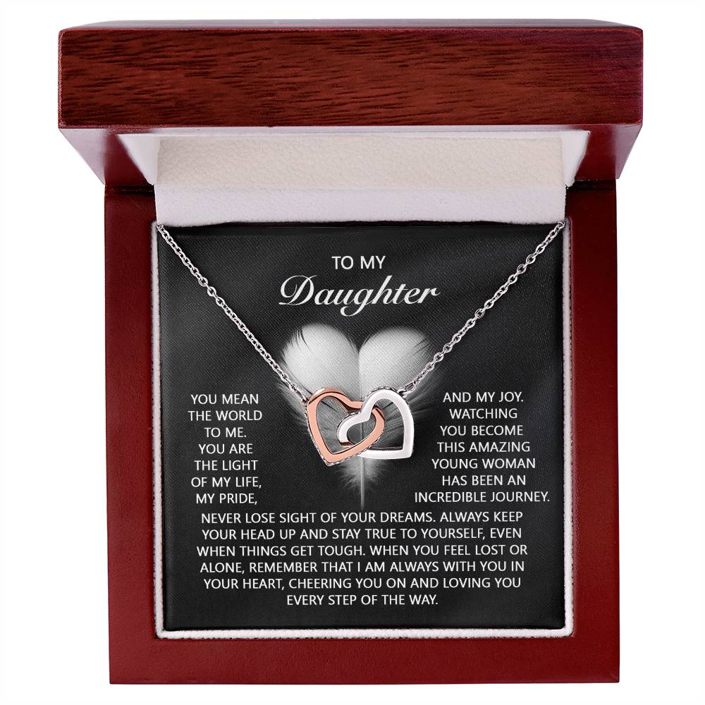 The "Daughter-In Your Heart" Interlocking Hearts Necklace features a striking silver finish and shimmering cubic zirconia crystals, nestled in a wooden box. It includes a touching message of love and encouragement for your daughter.