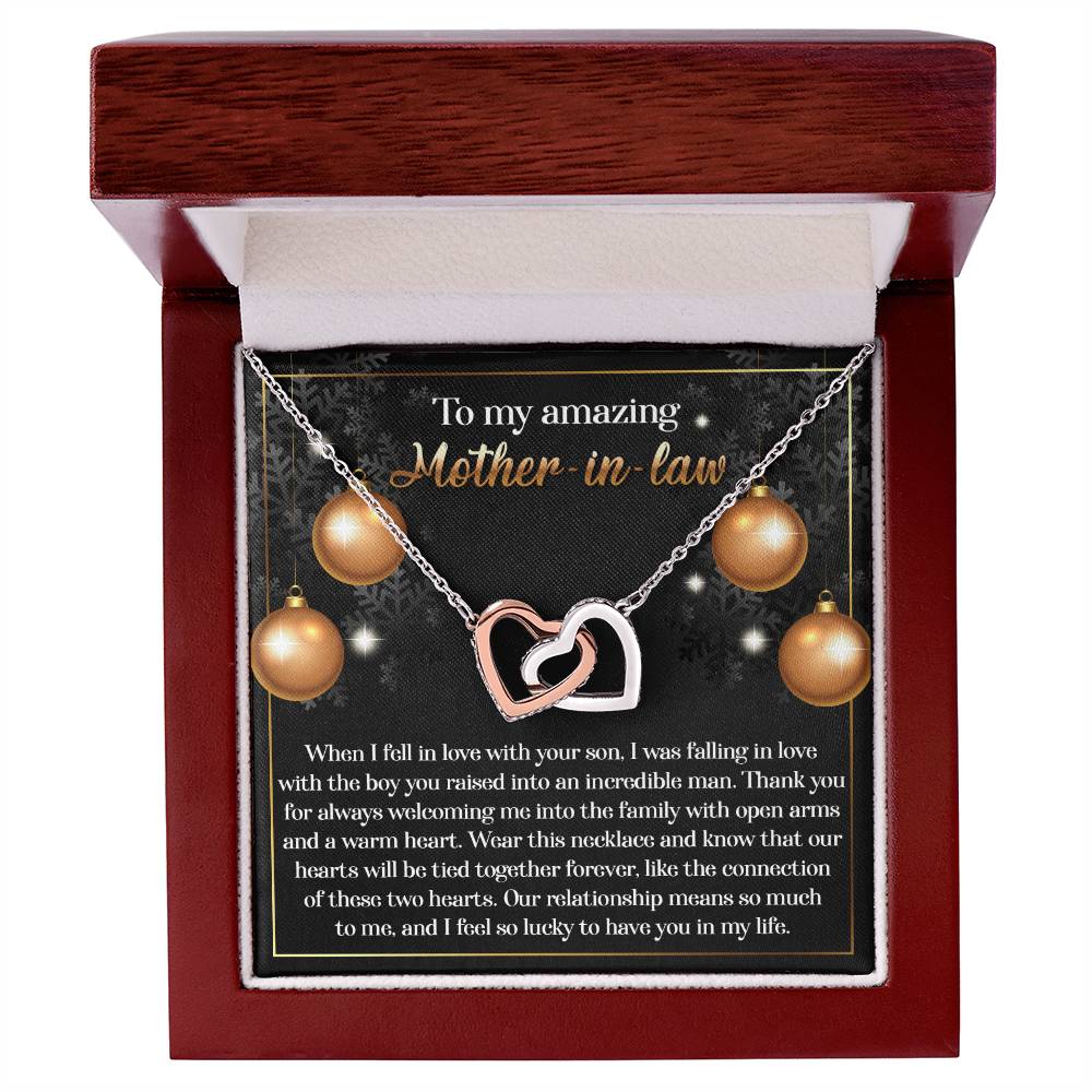 The Mother-in-Law-Two Hearts - Interlocking Hearts Necklace, embellished with cubic zirconia crystals, is beautifully presented in a jewelry box. Its rose gold finish adds to its allure, and it is accompanied by a heartfelt message that conveys gratitude and love to a beloved "mother-in-law.