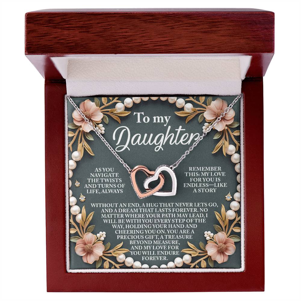 The Daughter-Endless Love - Interlocking Hearts Necklace is a stunning piece adorned with cubic zirconia crystals, presented in a red gift box with an elegant floral and pearl-themed background, complete with a heartfelt message for your daughter.