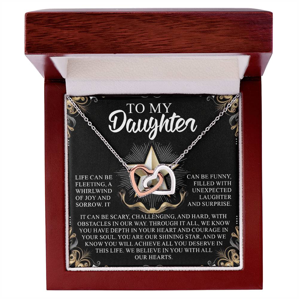 The Daughter-Shining Star - Interlocking Hearts Necklace, adorned with cubic zirconia crystals, sits elegantly in a decorative box. The inscription reads: "To my Daughter. Life can be fleeting... Every moment we share is forever nestled... you deserve in this life. We love you with all our hearts.