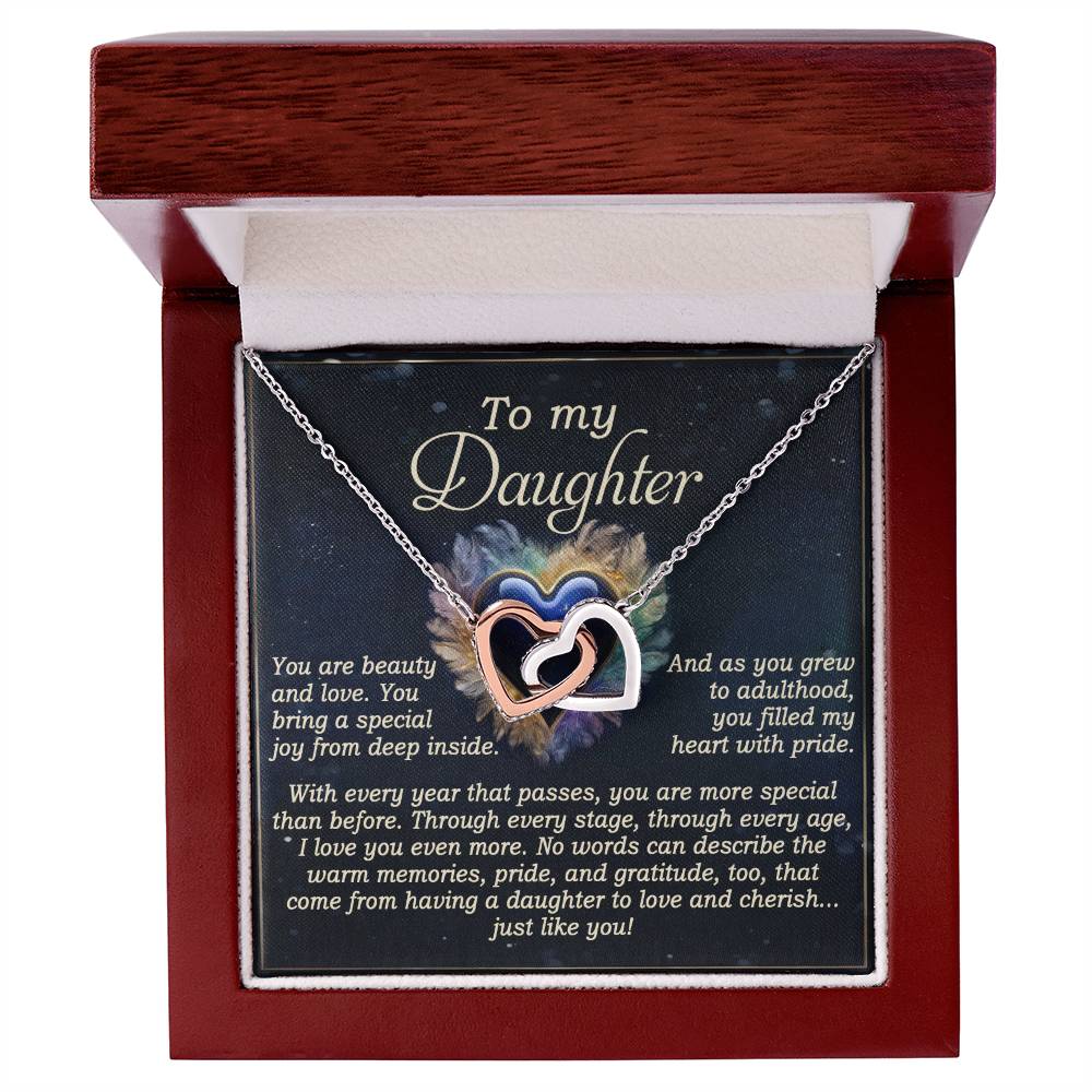 The Daughter-Like You - Interlocking Hearts Necklace, crafted in surgical steel and finished in rose gold, sparkles with cubic zirconia crystals. Presented in an open wooden box with the message "To my Daughter," it expresses pride and love for her unique presence.
