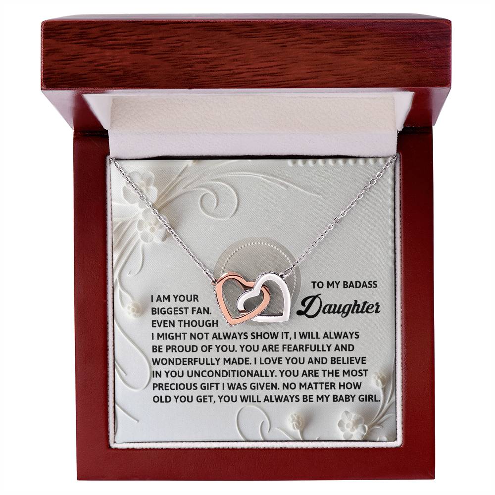 The Daughter-My Baby Girl - Interlocking Hearts Necklace has pendants with sparkling cubic zirconia crystals and a rose gold finish. It's housed in a wooden box with an engraved message of love and pride for a cherished daughter inside the lid.