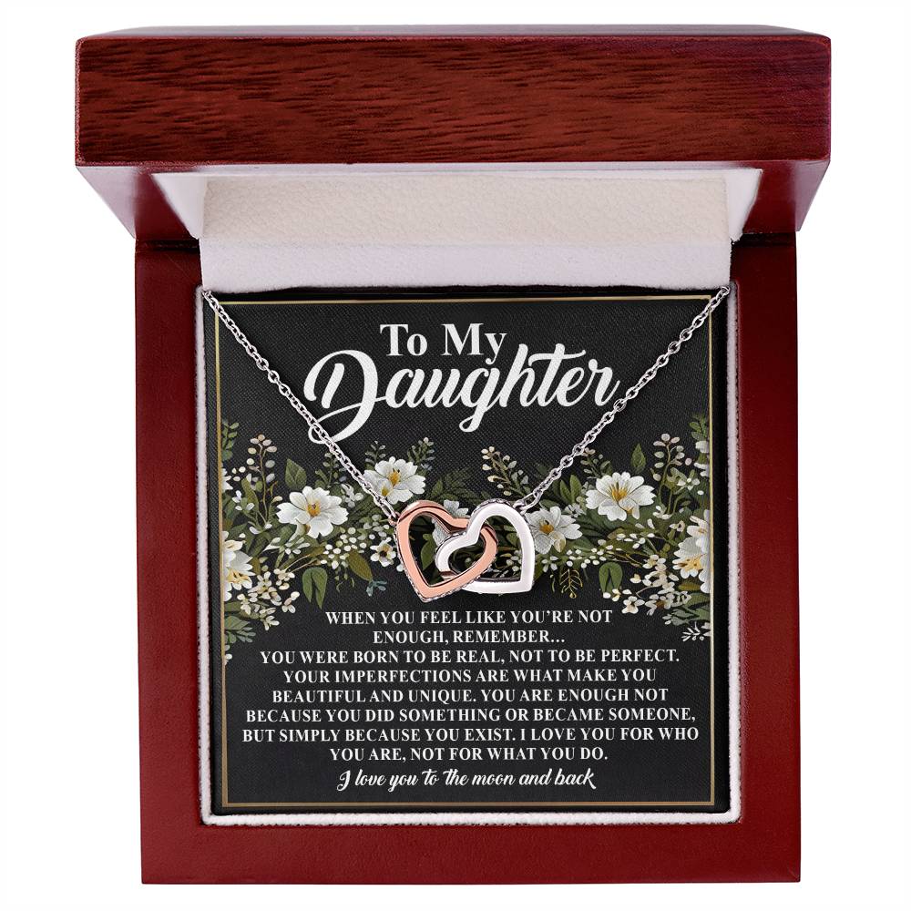 The Daughter-What You Do - Interlocking Hearts Necklace, featuring cubic zirconia crystals and a rose gold finish, comes in a wooden box with a floral "To My Daughter" message and a heartfelt love note.