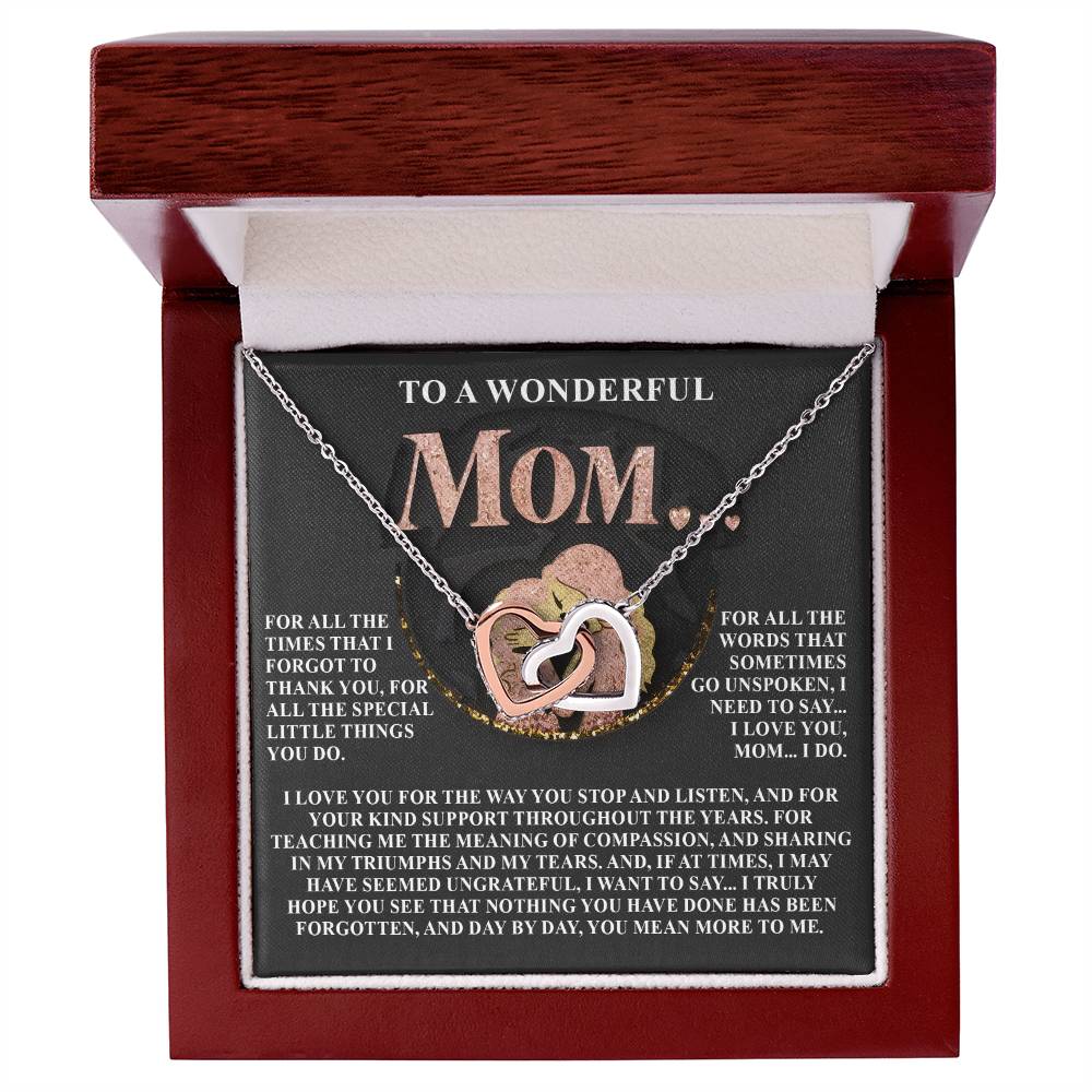 The Mom-More To Me 2 - Interlocking Hearts Necklace with an 18k yellow gold finish sparkles inside an open jewelry box, paired with a card expressing deep gratitude and love for a mother’s support, compassion, and daily acts of kindness.