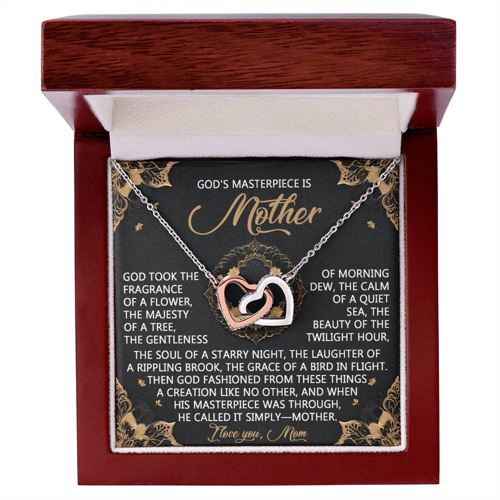 A jewelry box features the Mom-God’s Masterpiece - Interlocking Hearts Necklace in rose gold. The lid reveals an inscription celebrating a mother as "God's Masterpiece," accented by sparkling cubic zirconia crystals for added elegance.