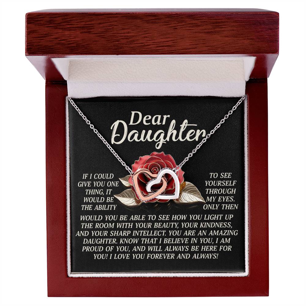 The Daughter-Your Light - Interlocking Hearts Necklace, featuring cubic zirconia crystals and a rose gold finish, is elegantly presented in an open wooden jewelry box with a heartfelt "Dear Daughter" message expressing love and admiration.