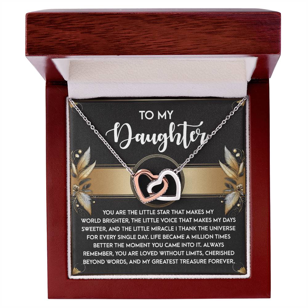 The Daughter-Greatest Treasure - Interlocking Hearts Necklace, adorned with cubic zirconia crystals, comes in a box labeled "To My Daughter," featuring a heartfelt message beneath.