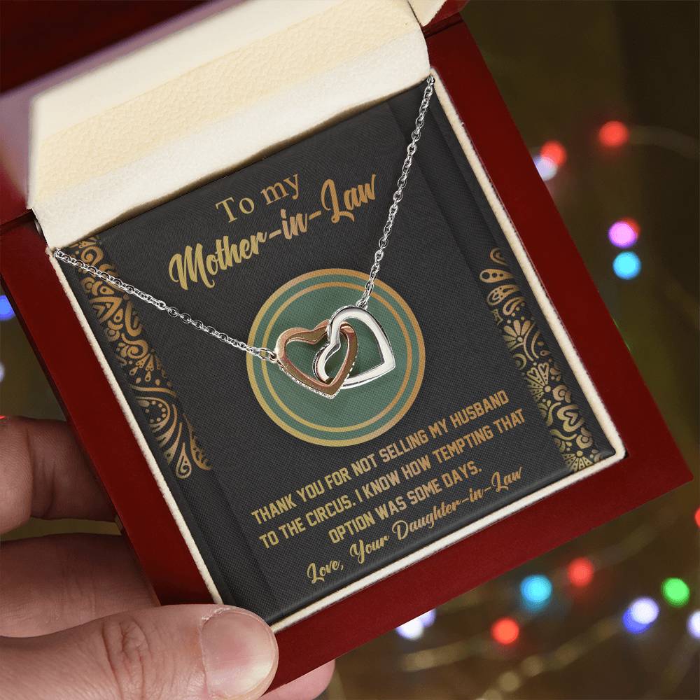The "To Mother-In-Law, Thank You" Interlocking Hearts Necklace is a charming gift adorned with cubic zirconia crystals and comes in a red box with a humorous message on the background card.