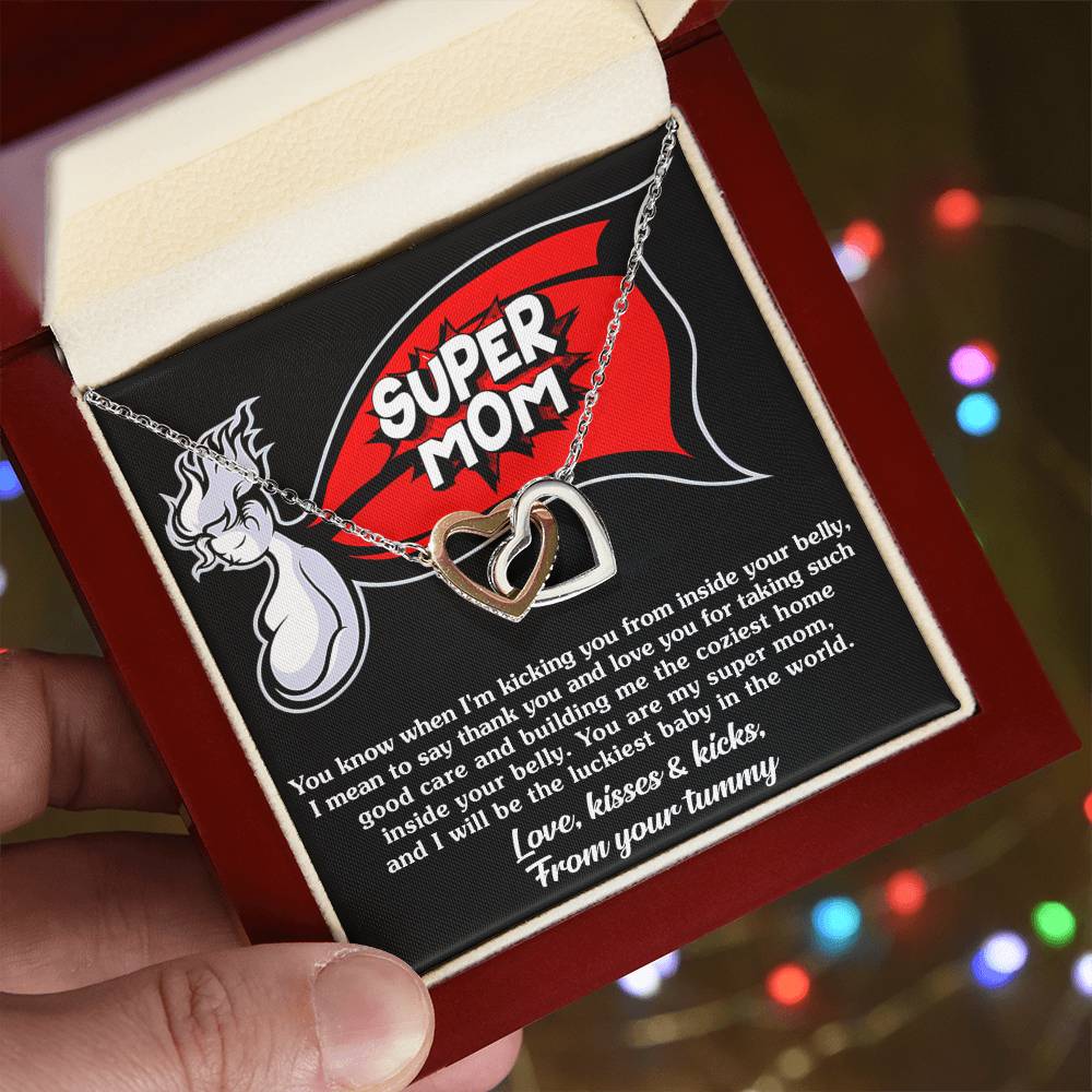 A To Mama To Be, My Super Mom - Interlocking Hearts Necklace by ShineOn Fulfillment, featuring an interlocking hearts design presented in a gift box, held in someone's hand.