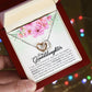 A To My Granddaughter, Always Keep Me In Your Heart, - Interlocking Hearts Necklace featuring interlocking hearts with a heart motif and an inscription for a granddaughter, presented in a floral gift box from ShineOn Fulfillment.