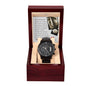 A black "Wedding, Down The Aisle - Metal Chronograph Watch" with a copper dial is displayed in an open dark wooden gift box, with a card inside the lid containing a printed message.