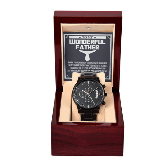 A black chronograph watch with a silver dial in a wooden box, featuring an inscription that reads "To Dad, My Best Friend," under a glass cover.
