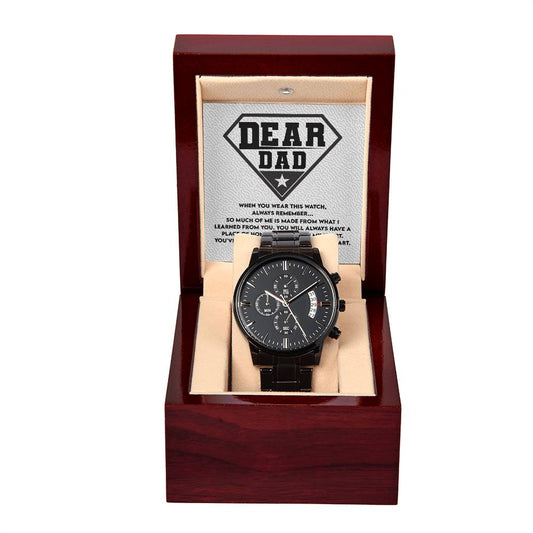 A "To Dad, Been My Hero" metal chronograph watch with a black strap and dial in a wooden box, under a lid displaying a message titled "Dear Dad.