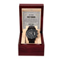 A black chronograph watch with a metallic band is displayed in an open red wooden box. Inside the lid of the box, a message titled "To My Best Man, All Your Support - Metal Chronograph Watch" features a heartfelt note.