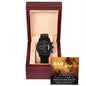 A black chronograph watch with a copper dial is elegantly displayed in an open wooden box. Inside the lid, a partially visible message featuring a lion image and text addressed to "Dad" adds a personal touch to this "To Dad, Repay Your Love - Metal Chronograph Watch".