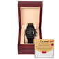 The "Sorry-Breaks My Heart - Metal Chronograph Watch," featuring a sleek black band, is elegantly displayed in an open wooden box. A note inside reads "I'm sorry!" followed by a brief apology message and a red heart illustration.