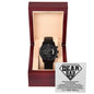 A "To Dad, Been My Hero" metal chronograph watch with a black strap and dial in a wooden box, under a lid displaying a message titled "Dear Dad.