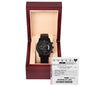 The "To Husband, Power of Love - Metal Chronograph Watch," featuring a black design with a dark face and calendar functions, is presented in an open wooden box engraved with a heartfelt message inside the lid.