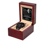 A black To My Husband-To-Be, Live A Day - Metal Chronograph Watch in a wooden display box with an engraved message on a plaque behind it.