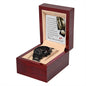 A black "Wedding, Down The Aisle - Metal Chronograph Watch" with a copper dial is displayed in an open dark wooden gift box, with a card inside the lid containing a printed message.