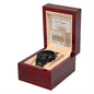 A black metal chronograph watch with a luxury copper dial comes in a red wooden box. Inside the lid, there's a small card labeled "Love Coupon" from the "To Husband, Coupon Book - Metal Chronograph Watch.