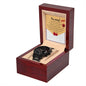The "Sorry-Breaks My Heart - Metal Chronograph Watch," featuring a sleek black band, is elegantly displayed in an open wooden box. A note inside reads "I'm sorry!" followed by a brief apology message and a red heart illustration.