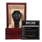 A "To Groomsman, Man Card - Metal Chronograph Watch" in black is elegantly presented inside an open wooden box with a beige interior. Beside the watch is a "Man Card: Groomsmen Edition" listing humorous wedding day codes for groomsmen, including tips like "Don't embarrass me," along with reminders to be punctual and well-groomed.