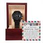 A black To Boyfriend's Dad, An Amazing Man - Metal Chronograph Watch is displayed in an open wooden box with a note thanking a boyfriend's father, describing him as an "Amazing Dad" who treats his girlfriend well.