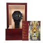 A black To Dad, Respected - Metal Chronograph Watch with a stainless steel bracelet is displayed inside a wooden box. Behind the watch is a card featuring a lion and the word "FATHER" with attributes like Friend, Ally, and Teacher written next to it.