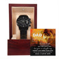 A black chronograph watch with a copper dial is elegantly displayed in an open wooden box. Inside the lid, a partially visible message featuring a lion image and text addressed to "Dad" adds a personal touch to this "To Dad, Repay Your Love - Metal Chronograph Watch".