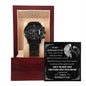 A black To My Husband-To-Be, Live A Day - Metal Chronograph Watch in a wooden display box with an engraved message on a plaque behind it.