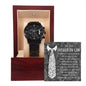 A "To Father-In-Law, Truly Blessed - Metal Chronograph Watch" inside a wooden box with a message card for a father-in-law in the background. The card features a tie design and expresses appreciation. The stainless steel watch has multiple dials, completing an elegant gift presentation.