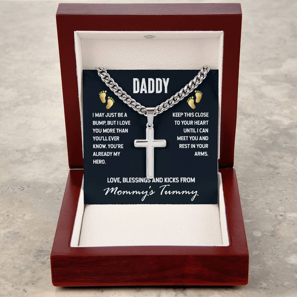 A hypoallergenic necklace with a stainless steel pendant in the shape of the Daddy-Just a Bump Cross on Cuban Link Chain, presented in a gift box. This piece features a sentimental message to a father from an unborn child by ShineOn Fulfillment.