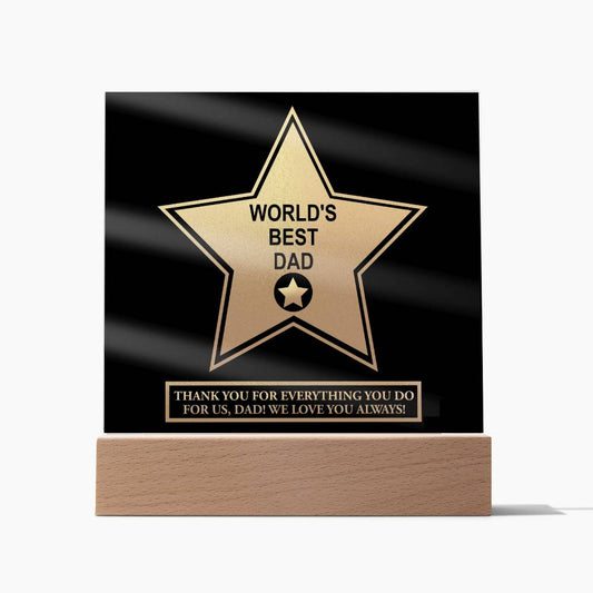 A unique sentimental gift, the "To Dad, World's Best Dad - Acrylic Square Plaque" on an LED wooden base displays a gold star and the text "WORLD'S BEST DAD." Below, a message reads, "THANK YOU FOR EVERYTHING YOU DO FOR US, DAD! WE LOVE YOU ALWAYS.