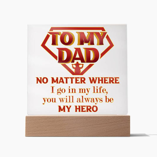 A sign with a sleek wooden base reads "TO MY DAD. NO MATTER WHERE I go in my life, you will always be MY HERO." in red and orange lettering with a hero emblem: To Dad, Be My Hero - Acrylic Square Plaque.