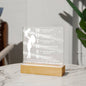 The "Mother Acronym Acrylic Plaque" is a touching gift featuring the word "MOTHER" vertically, with each letter starting a heartfelt phrase. A silhouette of a woman holding a child adorns the side, symbolizing enduring love—ideal for Mother's Day or as a birthday gift from children.