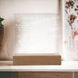 The "To Mom, Your Little One" acrylic plaque engraved with a heartfelt message and set on a wooden base is the perfect Mother's Day gift. Displayed with a decorative plant, it beautifully illuminates with LED lighting for your mom.