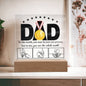 A framed acrylic plaque with the word "DAD" and a gold medal sits elegantly on an LED wooden base. Text underneath reads, "To the world, you may be just one person, but to me, you are the whole world," above three hand-drawn images of hands. A perfect sentimental gift for any father. This is the To Dad, The Whole World - Acrylic Square Plaque.