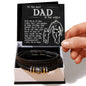 A hand presenting an open gift box containing the To Dad, By My Side - Love You Forever Bracelet and a card with a heartfelt message for 'the best dad in the world'.