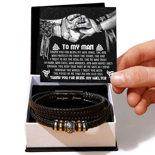 The "My Man-My Shelter" gift includes a vegan leather "Love You Forever" bracelet in a box with a card titled "To My Man," adorned with symbols and an illustration of two hands.