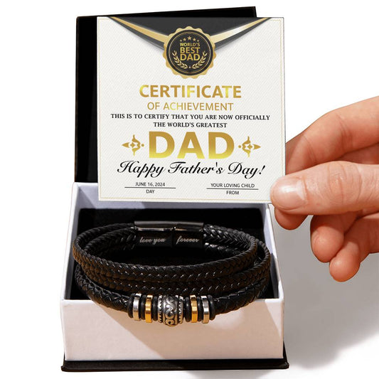A hand presents an open gift box containing a To Dad, Certificate of Achievement - Love You Forever Bracelet and a "world's best dad" certificate for father's day.